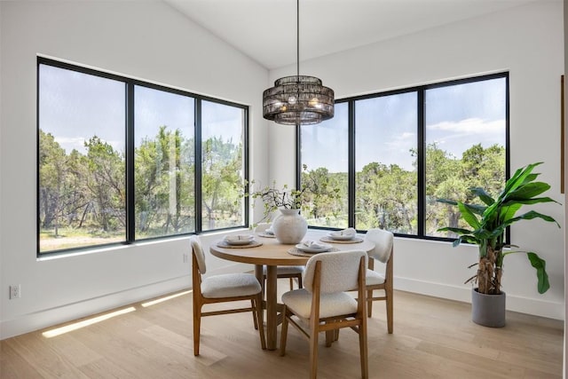 8112 Kuhn Dr, Austin, TX 78736 - dining area featuring a chandelier, healthy amount of natural light, light wood-style flooring, and vaulted ceiling