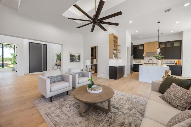 8112 Kuhn Dr, Austin, TX 78736 - living area featuring light wood-style floors, ceiling fan, recessed lighting, and a towering ceiling