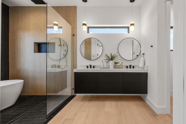 8112 Kuhn Dr, Austin, TX 78736 - bathroom featuring walk in shower, wood finished floors, double vanity, and a soaking tub