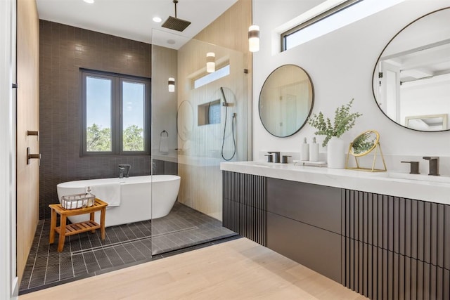 8112 Kuhn Dr, Austin, TX 78736 - full bath featuring double vanity, a freestanding bath, tile walls, a walk in shower, and recessed lighting