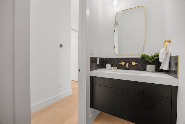 8112 Kuhn Dr, Austin, TX 78736 - bathroom featuring wood finished floors, vanity, and tasteful backsplash