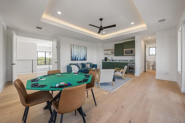 8112 Kuhn Dr, Austin, TX 78736 - recreation room with ceiling fan, wine cooler, a tray ceiling, light wood-type flooring, and recessed lighting