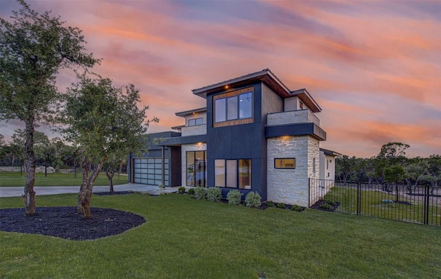 8112 Kuhn Dr, Austin, TX 78736 - modern home with a balcony, stone siding, a garage, and concrete driveway