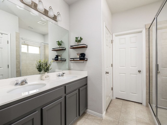 248 Brady Creek Way, Leander, TX 78641 - bathroom featuring a shower stall, double vanity, and tile patterned floors