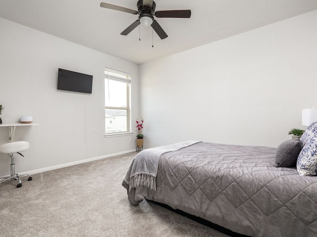 carpeted bedroom featuring baseboards and ceiling fan