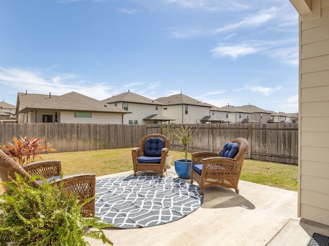 view of patio / terrace featuring a residential view and a fenced backyard