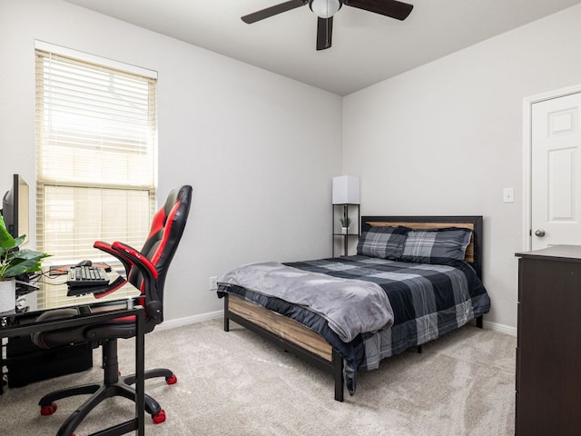 bedroom with ceiling fan, baseboards, and light carpet