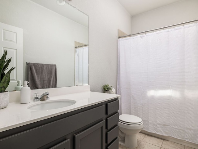 full bathroom with a shower with shower curtain, toilet, vanity, and tile patterned flooring