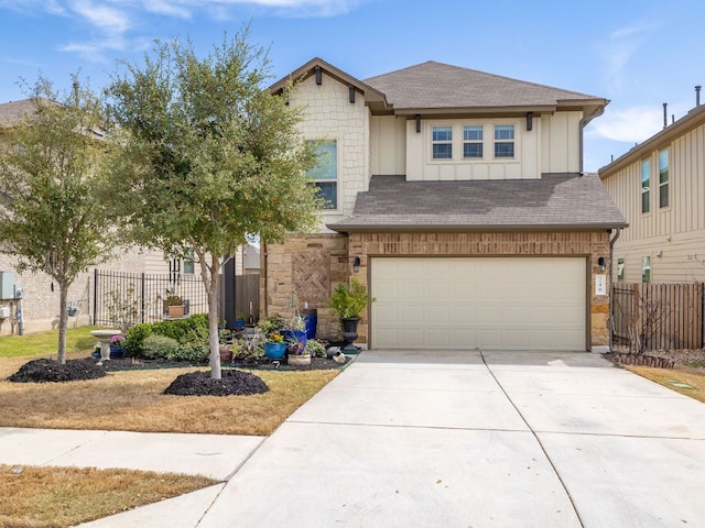 view of front of home with concrete driveway, fence, a garage, and a shingled roof