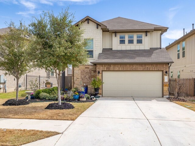 248 Brady Creek Way, Leander, TX 78641 - view of front of house with an attached garage, driveway, a shingled roof, and board and batten siding