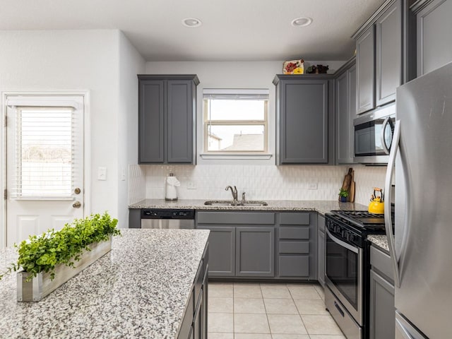 248 Brady Creek Way, Leander, TX 78641 - kitchen featuring stainless steel appliances, a sink, gray cabinetry, decorative backsplash, and recessed lighting