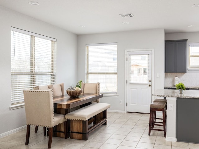 dining room with light tile patterned floors, visible vents, baseboards, and recessed lighting