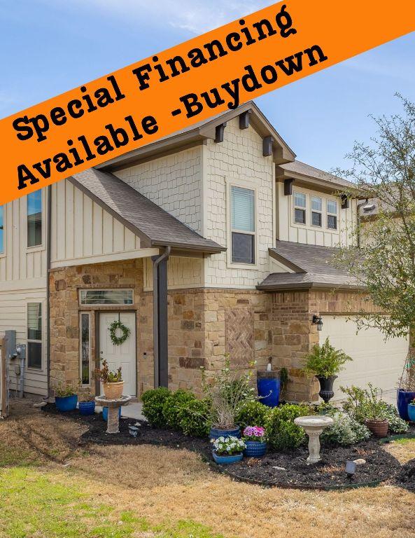 248 Brady Creek Way, Leander, TX 78641 - view of front facade with board and batten siding, stone siding, and a garage