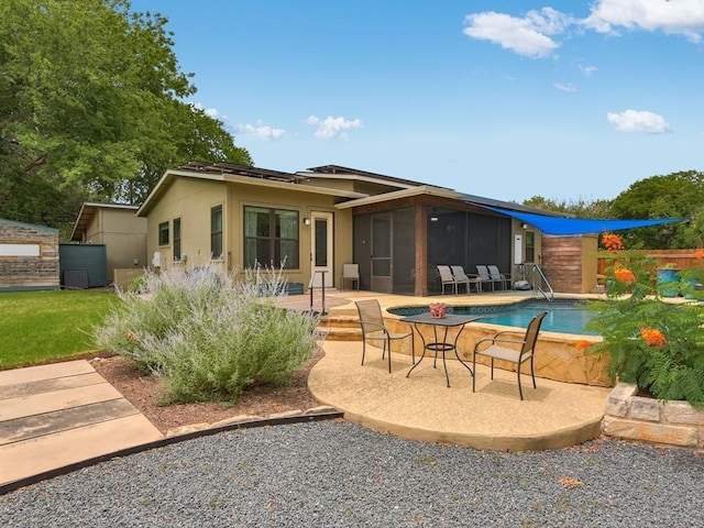 back of house featuring stucco siding, fence, a sunroom, a fenced in pool, and a patio area