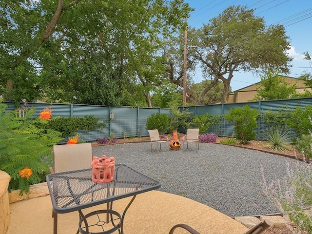 view of patio / terrace featuring a fenced backyard and an outdoor fire pit