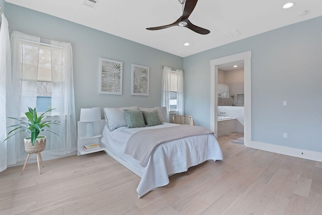 bedroom with baseboards, visible vents, light wood finished floors, recessed lighting, and ensuite bathroom