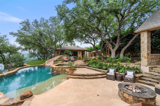 outdoor pool with a patio, fence, a water slide, an in ground hot tub, and a fire pit