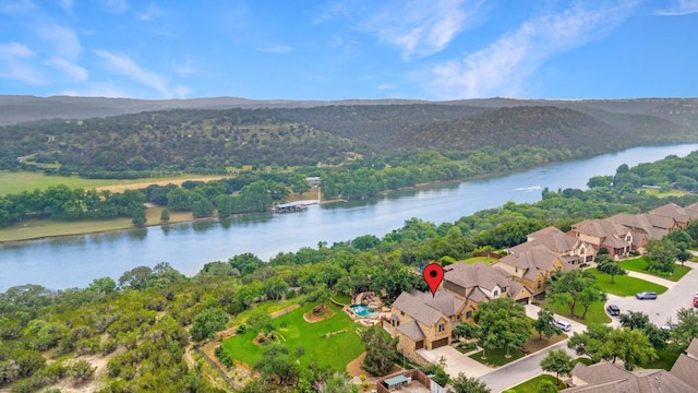 aerial view featuring a wooded view and a water view