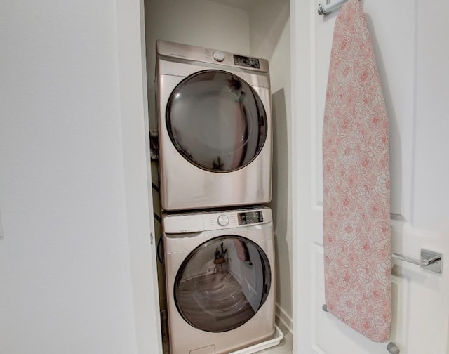 washroom featuring laundry area and stacked washer and dryer