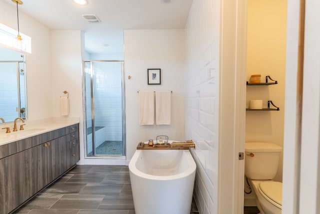 bathroom featuring visible vents, vanity, toilet, and a shower stall