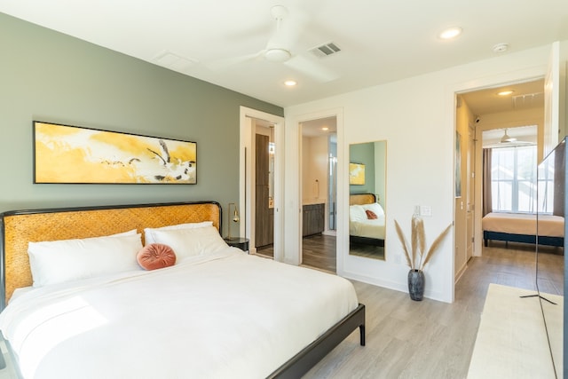 bedroom featuring light wood finished floors, visible vents, baseboards, recessed lighting, and a ceiling fan