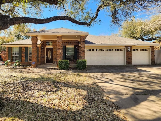 view of front of home with brick siding, concrete driveway, and a garage