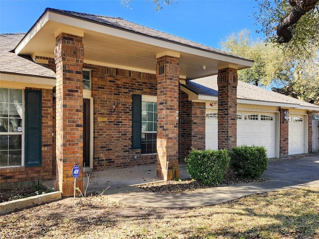 exterior space with brick siding and a garage