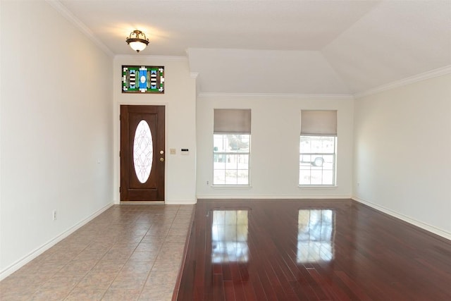 entryway with wood finished floors, baseboards, and ornamental molding