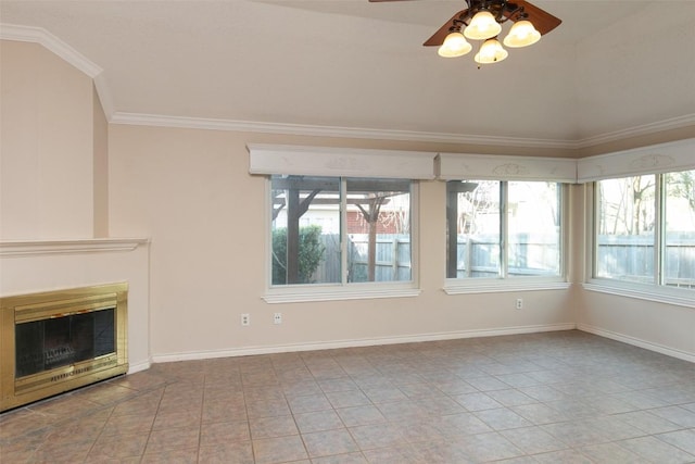 unfurnished living room featuring a glass covered fireplace, baseboards, crown molding, and ceiling fan