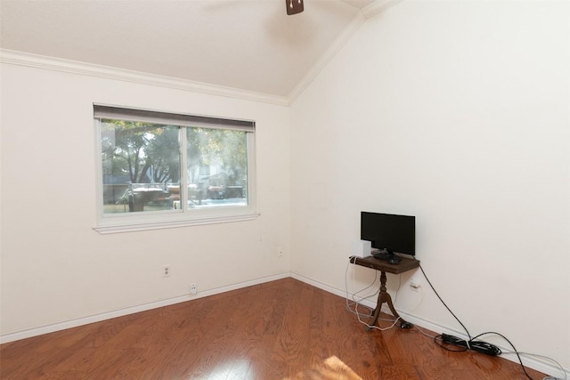 interior space with lofted ceiling, wood finished floors, crown molding, baseboards, and ceiling fan