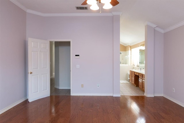 unfurnished bedroom with visible vents, baseboards, light wood-style flooring, and crown molding