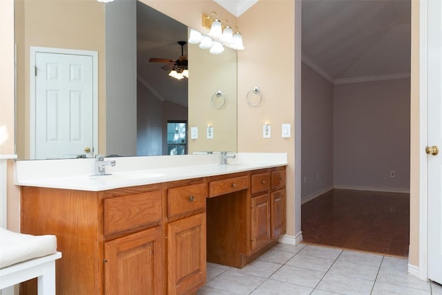 bathroom with double vanity, ceiling fan, a sink, crown molding, and tile patterned floors