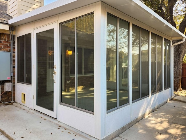 view of property exterior with a sunroom