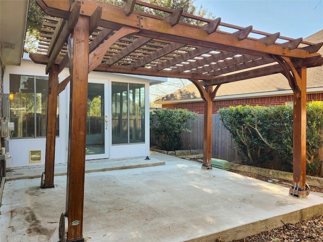 view of patio / terrace with french doors, a pergola, and fence