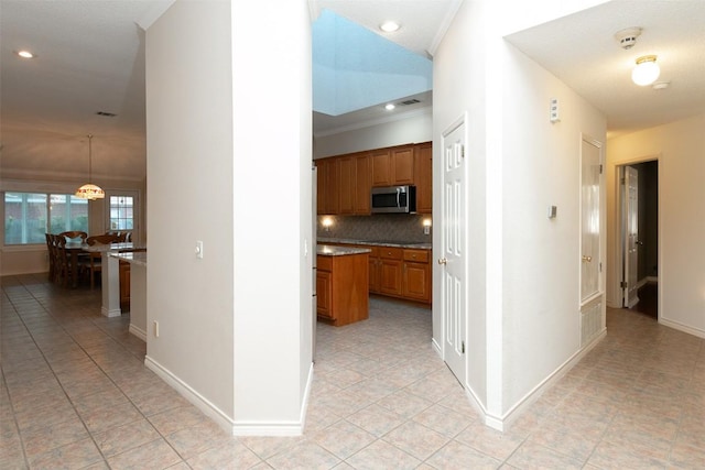 hallway featuring crown molding, light tile patterned floors, recessed lighting, and baseboards