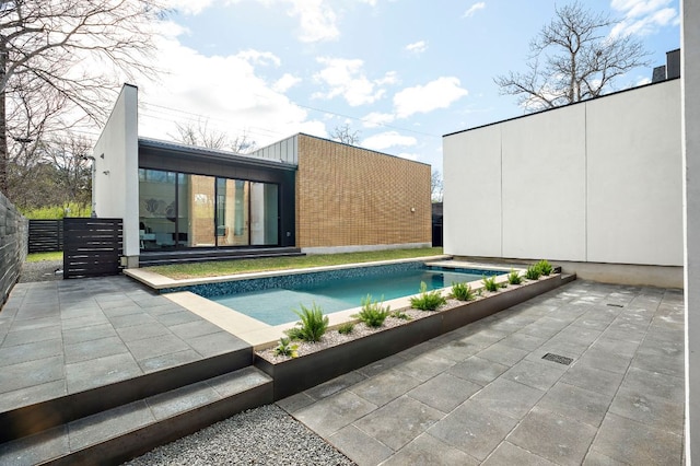 outdoor pool featuring a patio and fence