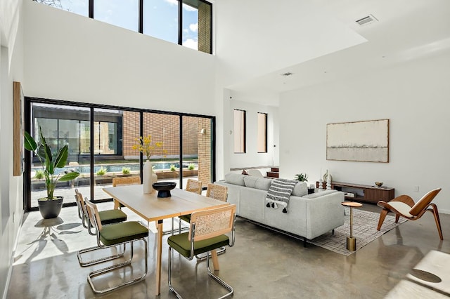 2603 Little John Ln, Austin, TX 78704 - living area with finished concrete flooring, a high ceiling, and plenty of natural light