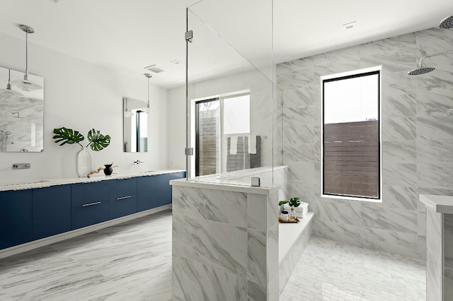 bathroom featuring a marble finish shower and vanity