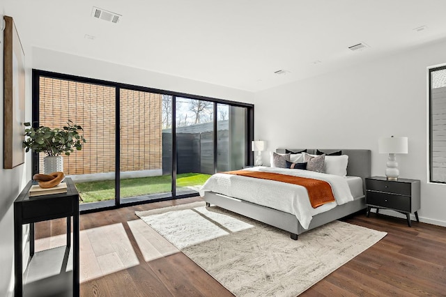 bedroom featuring visible vents and wood finished floors