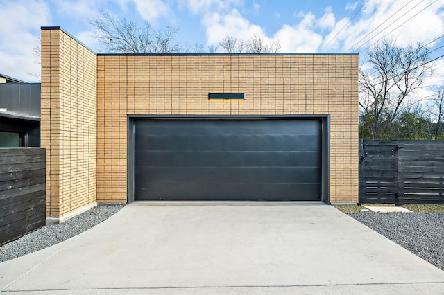 garage with driveway and fence