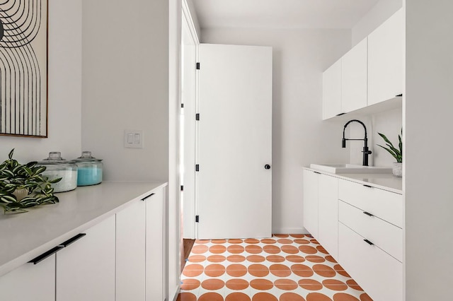 2603 Little John Ln, Austin, TX 78704 - laundry room featuring a sink and tile patterned floors