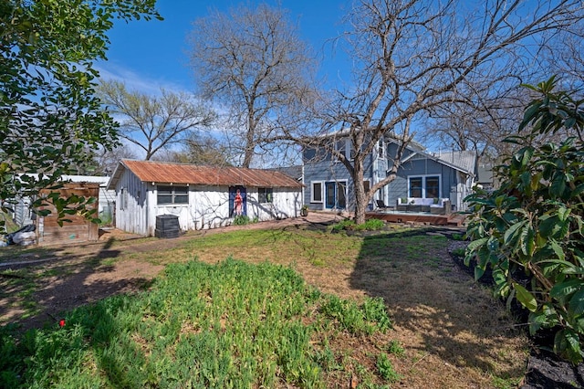 view of front of house with a wooden deck and an outdoor structure