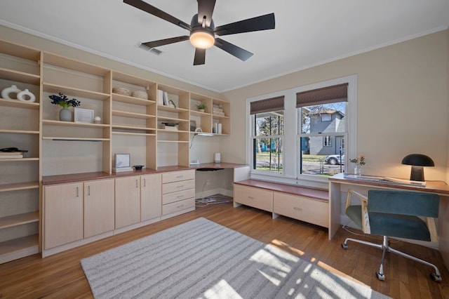 home office featuring a ceiling fan, wood finished floors, and visible vents