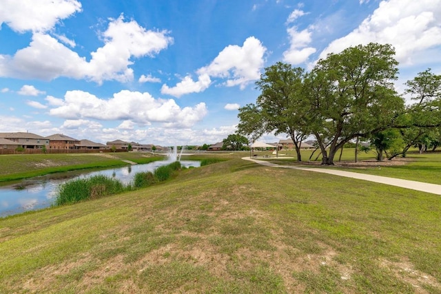 exterior space featuring a yard, a water view, and a residential view