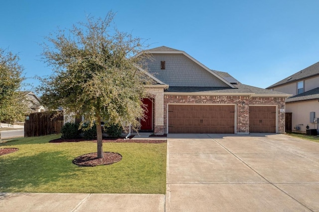 view of front of property with an attached garage, concrete driveway, a front yard, and fence