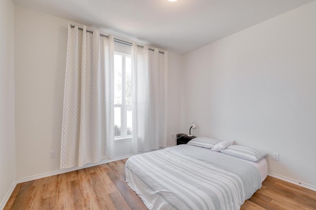 1004 Brenham Ln, Leander, TX 78641 - bedroom featuring multiple windows and wood finished floors