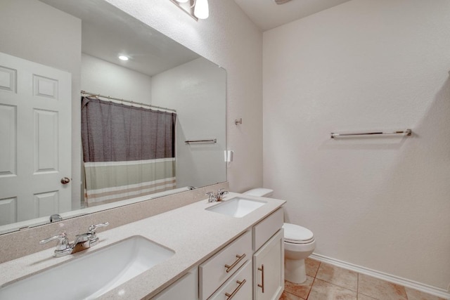 full bathroom with tile patterned flooring, double vanity, toilet, and a sink