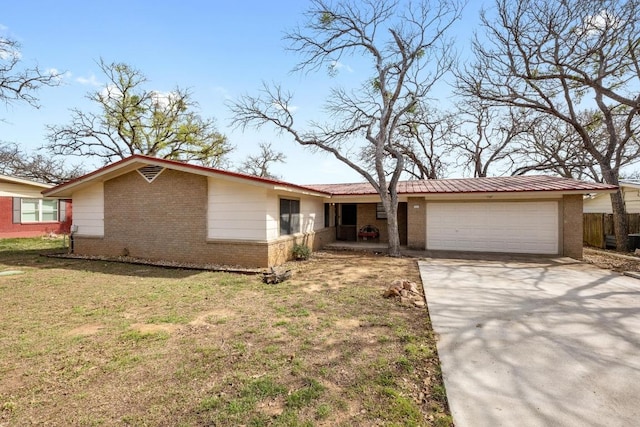 single story home featuring brick siding, a front lawn, concrete driveway, and a garage