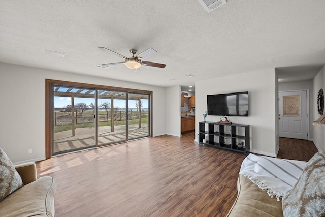 126 Lakeview Dr, Buchanan Dam, TX 78609 - living area with baseboards, dark wood-style floors, visible vents, and ceiling fan
