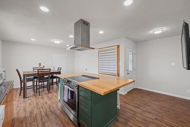 kitchen with dark wood-style floors, wooden counters, island exhaust hood, stainless steel electric range, and green cabinets